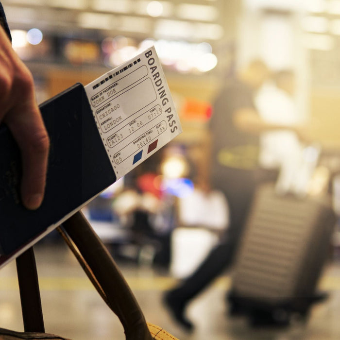 autistic adult holding a boarding pass while in the airport.