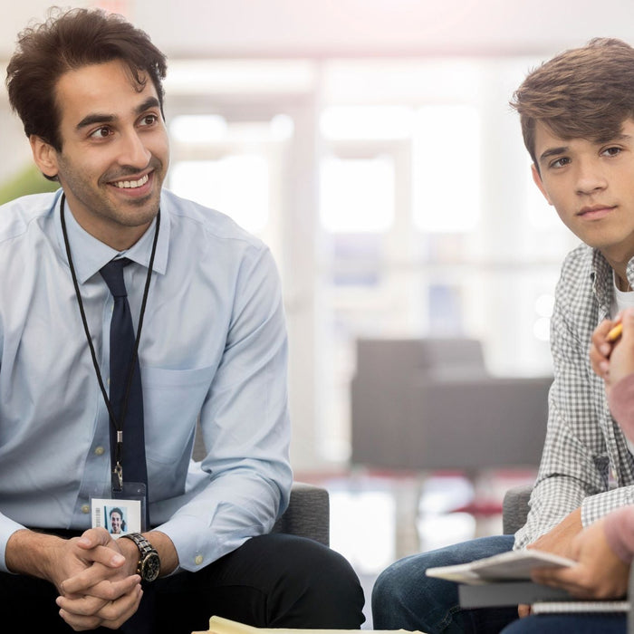 Teacher and student talking with a school administrator.