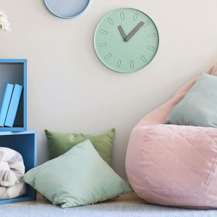 Self-regulation station with a bean bag chair, pillows, blanket, and clock