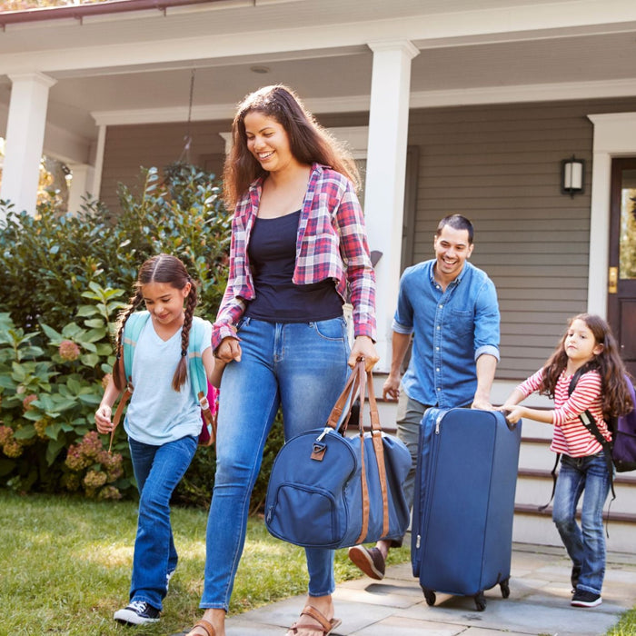 family leaving their house to go on vacation