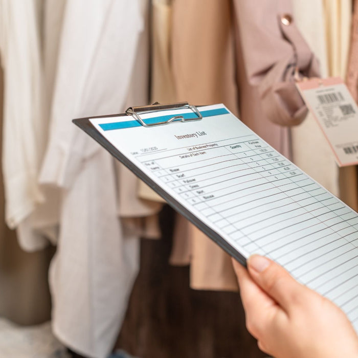 Individual with clipboard at the store comparing prices.