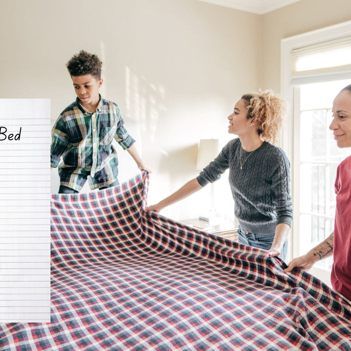 three people making a bed, notebook with the task: making a bed broken down into 6 steps.
